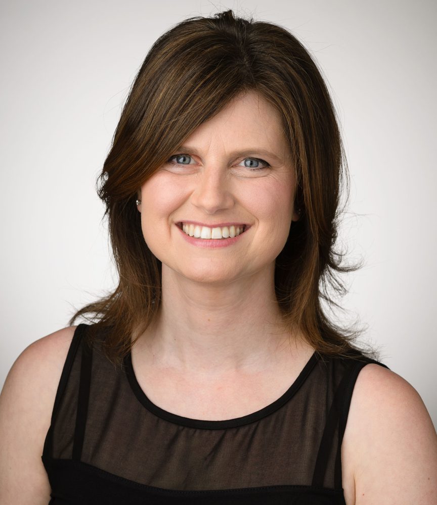 Headshot of a smiling woman with brown hair. Headshot of a smiling woman with brown hair.