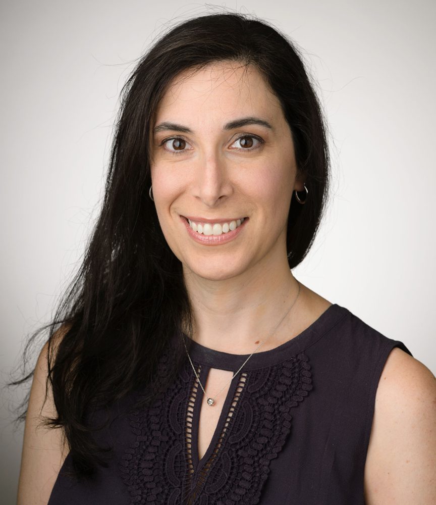 Headshot of smiling woman with dark hair. Headshot of smiling woman with dark hair.